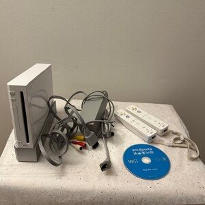 Wii console with plugs, 2 remotes, and Wii sports